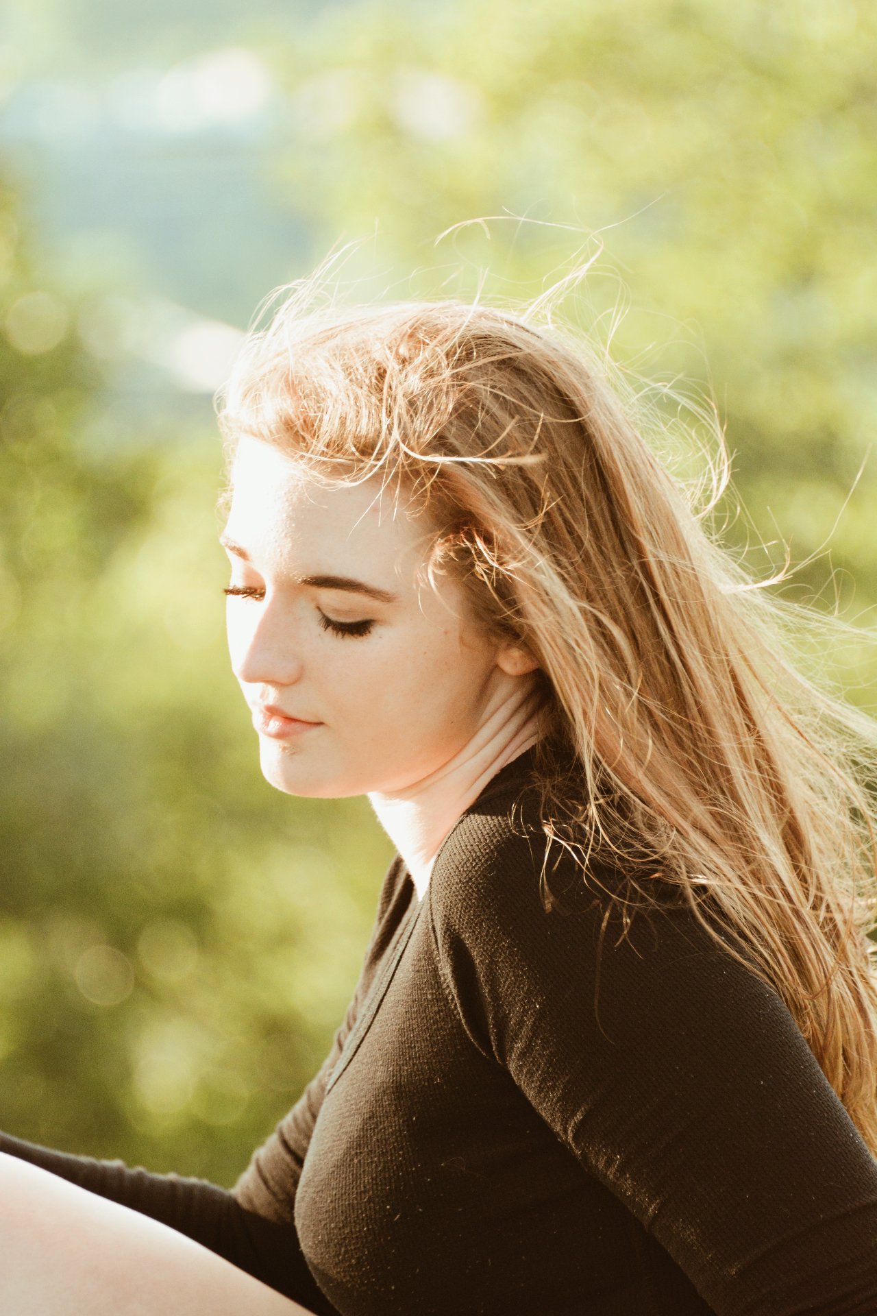 Profile portrait of a blonde woman with wind in her hair